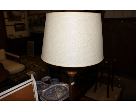 A mahogany standard lamp and shade
