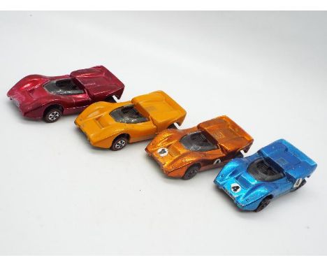 Hot Wheels - Redline - 4 x McLaren M6A models in Blue, Orange, Enamel Orange and Rose (?). They all appear in Good condition 
