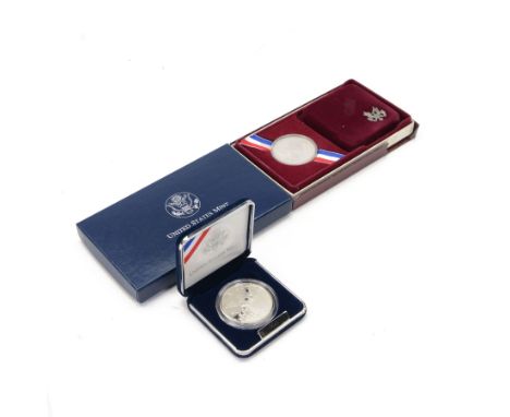Two United States Mint silver proof dollar coins, comprising 1984 'Los Angeles Olympics' and 2002 'Salt Lake City Olympic Win