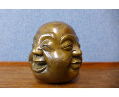 A small oriental bronze four faced Buddha, 12cms h 