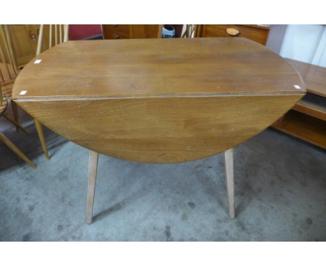 An Ercol Blonde beech and elm drop-leaf table, 72cms h, 113cms l, 63cms w 