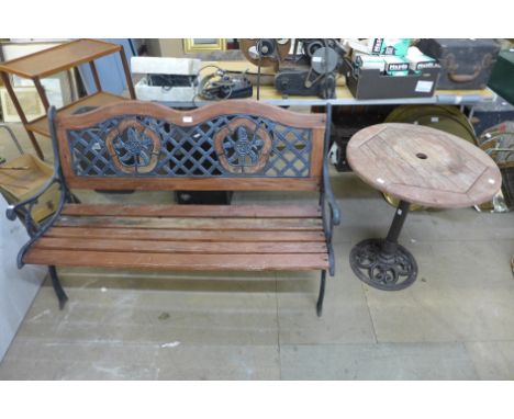 A cast iron ended garden bench and a circular garden table 