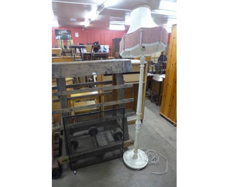 A cream standard lamp and a metal firescreen 