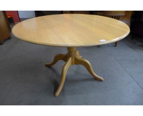 An Ercol Chester elm and beech circular table 