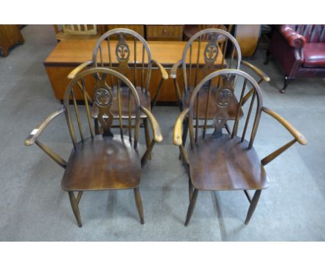 A set of four Ercol Golden Dawn elm and beech fleur de lys chairs 