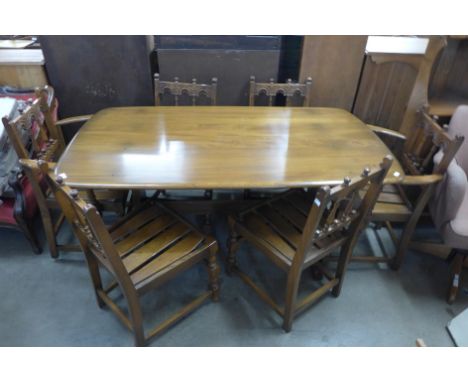 An Ercol Golden Dawn elm and beech eight piece dining suite 