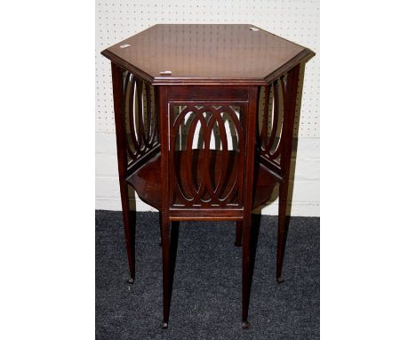 An Edwardian mahogany lamp table, the satinwood crossbanded hexagonal top over pierced panel sides on square tapering legs an
