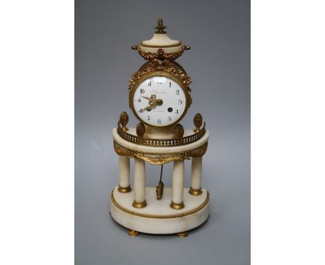 Planchon of Paris (Palais- Royal). A white marble and urmolu  mounted demi lune portico clock with eight day movement. Chimin