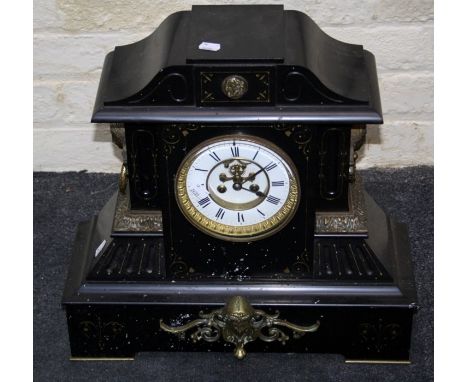 A Victorian black slate mantle clock, the architectural case applied with gilt metal masks containing an eight day gong strik