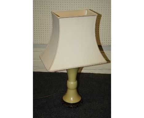 A Chinese Gu shape yellow ground table lamp with&nbsp; pierced hardwood stand and silk shade. 34 cms (excluding shade).