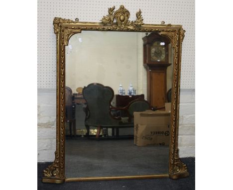 A 19th century giltwood and gesso overmantle mirror, the shield and acanthus surmount above egg and bead moulded frame and pl