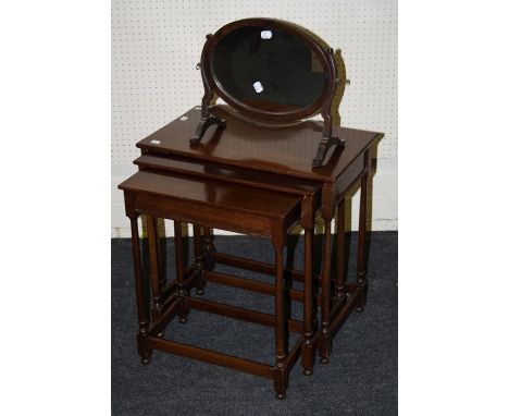 A Geo III style nest of three mahogany inter-sliding occasional tables with slender turned supports, 56cm wide. Together with