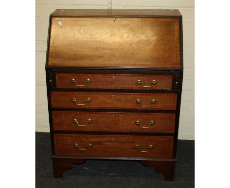 An Edwardian mahogany lady's writing bureau, the fan inlaid fall enclosing scriber and fitted interior over four graduated lo