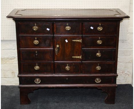 A 19th century mahogany crossbanded, oyster veneer chest, the associated top over an arrangement of ten drawers around a cupb