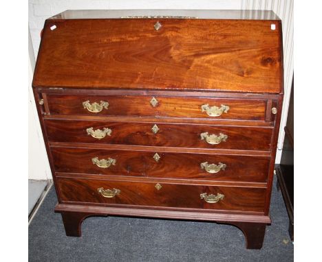 A Geo.III mahogany bureau with applied gilt metal mount over a well-fitted fall and four long graduated drawers on bracket fe