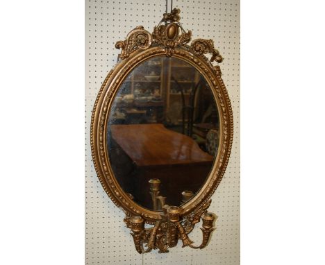 A 19th century giltwood and gesso three branch girondole wall mirror with plain oval plate and bead decorated frame. 85 x 52 
