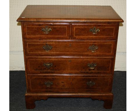 A Geo I/II herringbone banded walnut chest of two short over two long drawers, with cross grain moulding and quartered top.ra