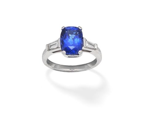 TANZANITE AND DIAMOND RING, 2007The cushion-shaped tanzanite, between tapered baguette-cut shoulders, mounted in 18 white car