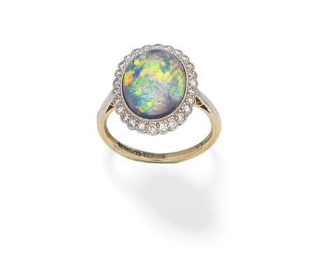 OPAL AND DIAMOND CLUSTER RINGThe oval opal cabochon within a single-cut diamond surround, ring size approx. N½ For further in