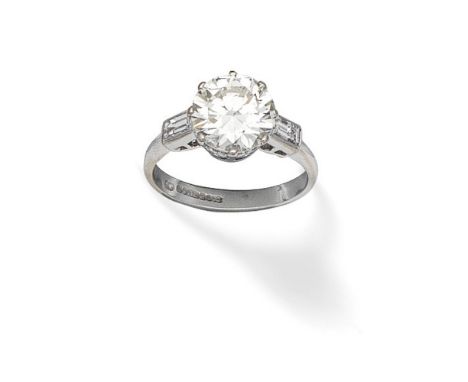 DIAMOND SINGLE-STONE RING, 1996The old brilliant-cut diamond, weighing 3.04 carats, between baguette-cut diamond shoulders, m