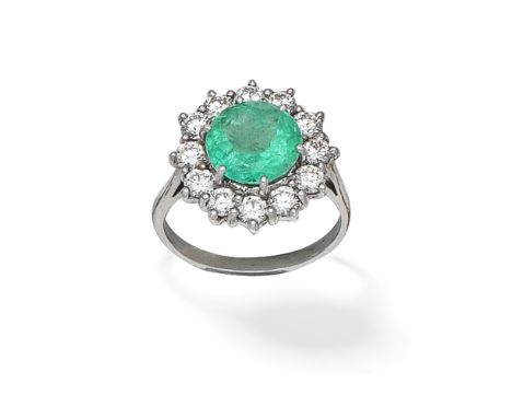 EMERALD AND DIAMOND CLUSTER RINGThe circular-cut emerald within a surround of brilliant-cut diamonds,  diamonds approx. 1.80c