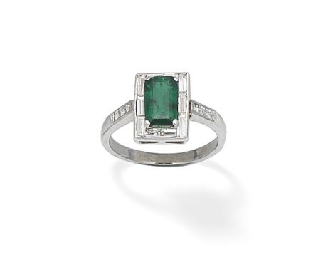 EMERALD AND DIAMOND RINGThe octagonal step-cut emerald within a baguette-cut diamond surround, between square-cut diamond sho