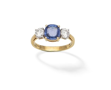 SAPPHIRE AND DIAMOND THREE-STONE RING, 1997The cushion-shaped sapphire between brilliant-cut diamonds, mounted in 18 carat go