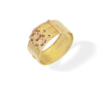 SEED PEARL-SET GOLD BANGLE, LATE 19TH CENTURYOf hinged design, the central buckle motif set with seed pearls, with engraved d