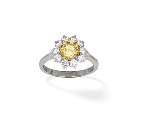 COLOURED DIAMOND AND DIAMOND CLUSTER RINGThe brilliant-cut diamond of yellow brown tint within a brilliant-cut diamond surrou