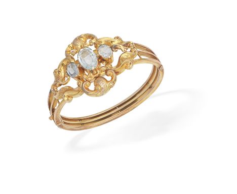 GEM-SET BANGLE, CIRCA 1890The trifurcated hinged bangle, set to the front with three oval-cut aquamarines within an openwork 