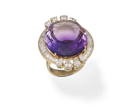 AMETHYST AND DIAMOND RINGThe central oval-cut amethyst within a surround of baguette, tapered baguette and pear-shaped diamon