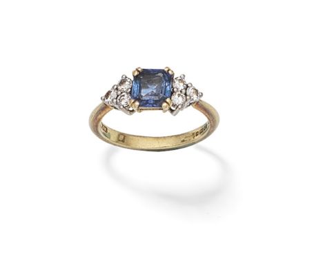 SAPPHIRE AND DIAMOND RINGSet with an octagonal step-cut sapphire between trios of brilliant-cut diamonds, mounted in 18 carat