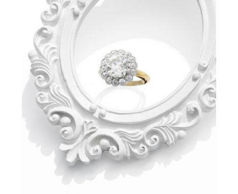 DIAMOND CLUSTER RINGThe central cushion-shaped diamond, weighing 3.27 carats, within an old brilliant-cut diamond surround,  