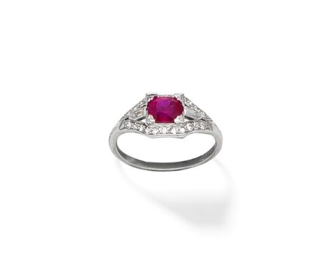 RUBY AND DIAMOND RINGThe oval-cut ruby within an openwork surround set with single and baguette-cut diamonds,  ring size appr