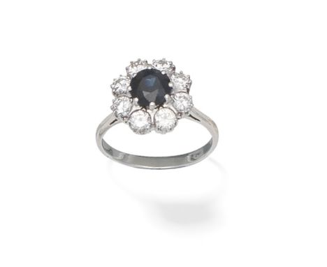 SAPPHIRE AND DIAMOND CLUSTER RINGThe circular-cut sapphire within a brilliant-cut diamond surround, diamonds approx. 0.55ct t