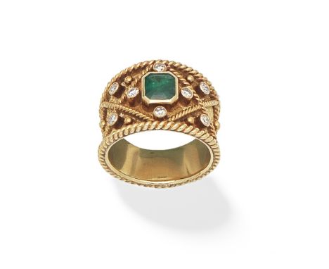 EMERALD AND DIAMOND DRESS RING, 1980The tapering 18 carat gold band with a central octagonal step-cut emerald and single-cut 