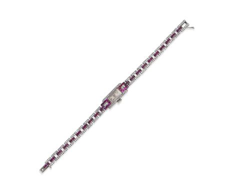 ART DECO RUBY AND DIAMOND COCKTAIL WATCH, CIRCA 1920The rectangular, cream dial with Arabic hourmarkers, the bezel, lugs and 