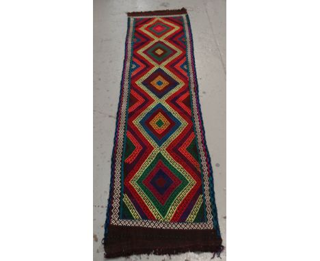 A multi-coloured Suzni runner, 289 x 66cms