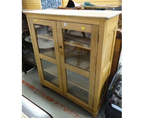 A vintage light oak glass two-door bookcaseHeight -  123cmsWidth – 119cmsDepth – 42cms