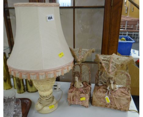 A pair of early twentieth century doll table lamps both 'sat up in bed' with silk bed-clothes and lacework canopies (one lamp
