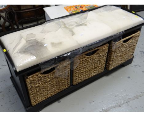A black ash cushioned bench with wicker storage basket bottom