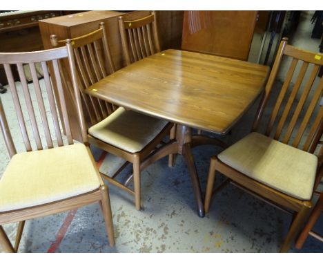 A good light oak Ercol extending dining table together with four matching splat back chairs