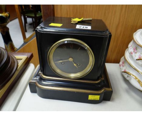 A black marble, gilt & brass decorated mantel clock