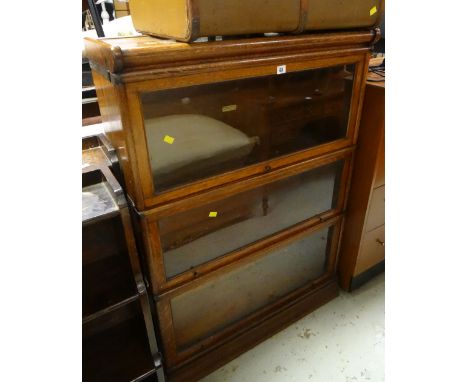 A good light oak three-section Globe Wernicke bookcaseThe height is 121cmsThe width is 87cmsThe depth is 31cms