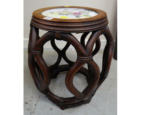 An Oriental hardwood stool with decorated ceramic seatThere are a few surface scratches to the ceramic top and there are a fe