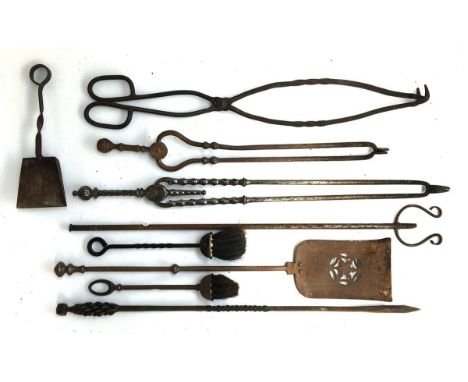 A good selection of wrought iron fire tools, to include tongs, pokers, shovels, brushes, etc (9) 