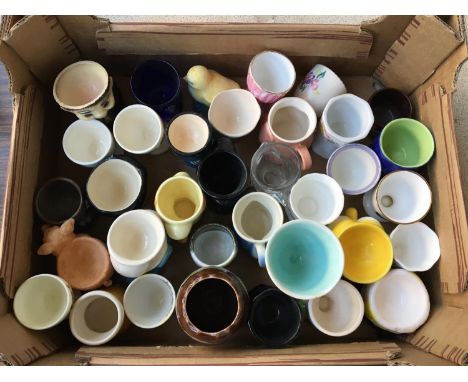 A mixed lot of eggcups to include Poole pottery and other novelty designs, approx. 33 
