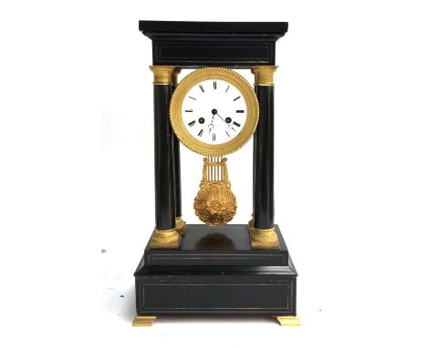 An ebonised and parcel gilt portico mantel clock, dial supported below pediment top, on four tapering columns, gilt based wit