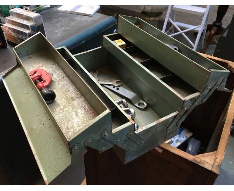 A metal toolbox containing a small quantity of spanners 