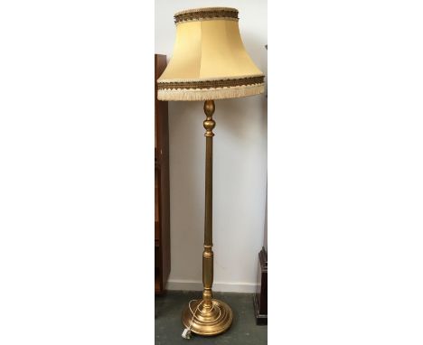 A gilt standard lamp with shade 